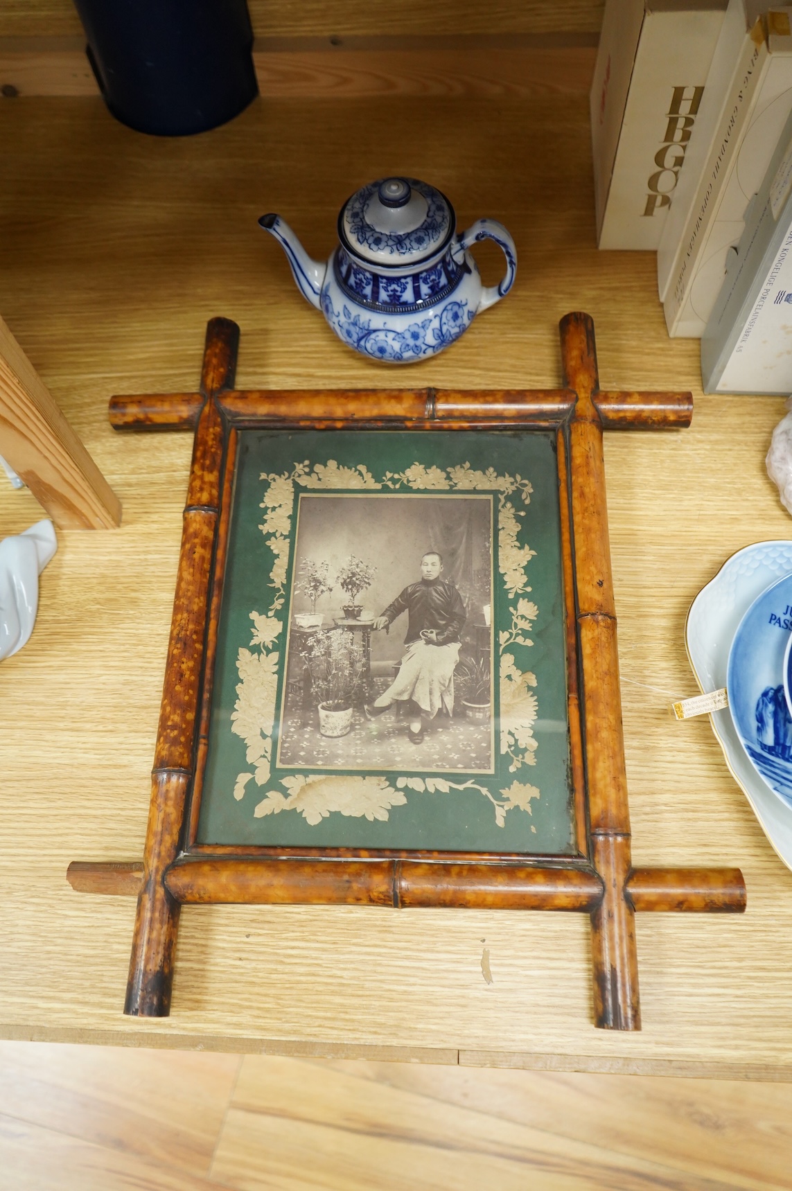 A MacIntyre Burslem blue and white teapot, c.1900, 15cm high and an early 20th century Chinese portrait photograph in a bamboo frame